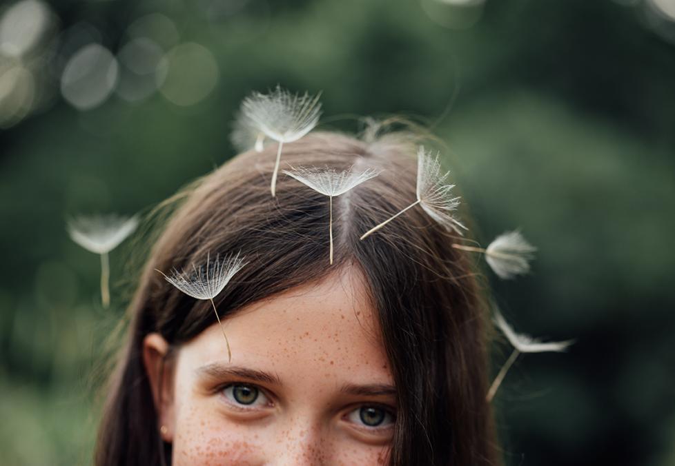 Kid with dandelions on head