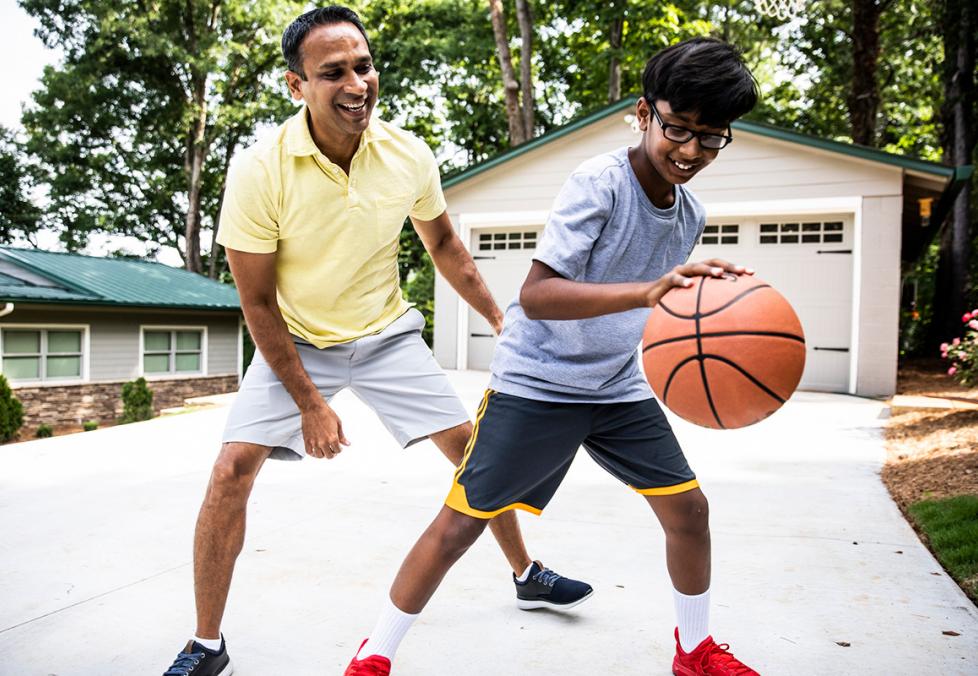 Father and son playing basketball together