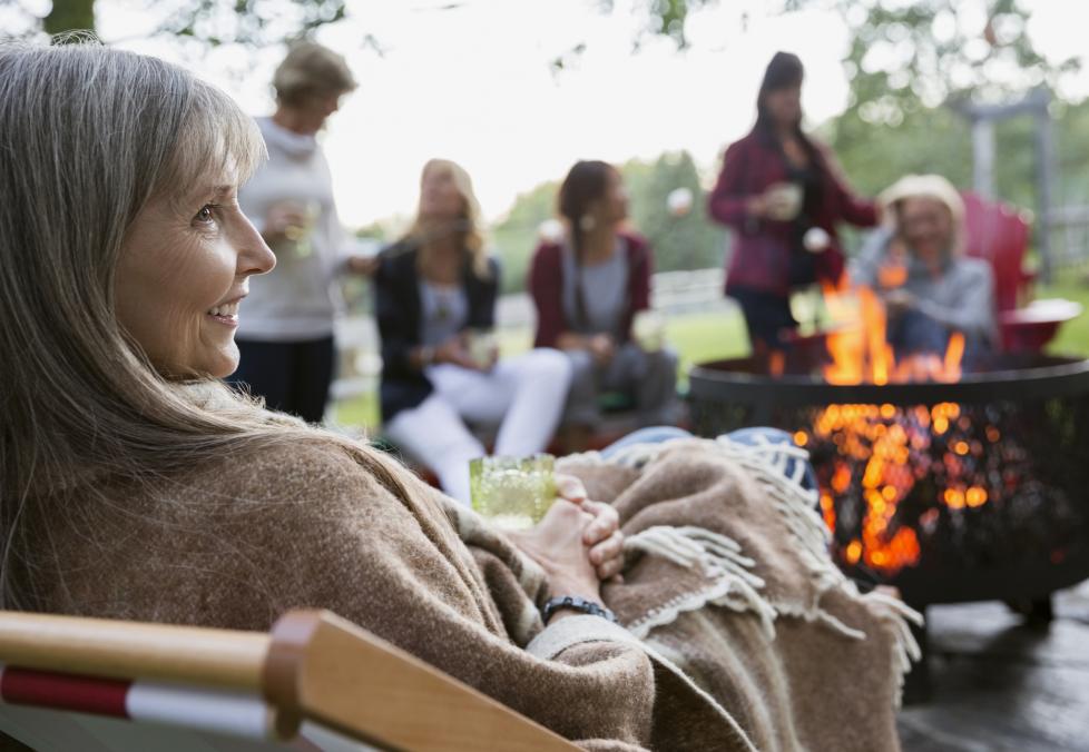 Happy woman with friends at outdoor gathering