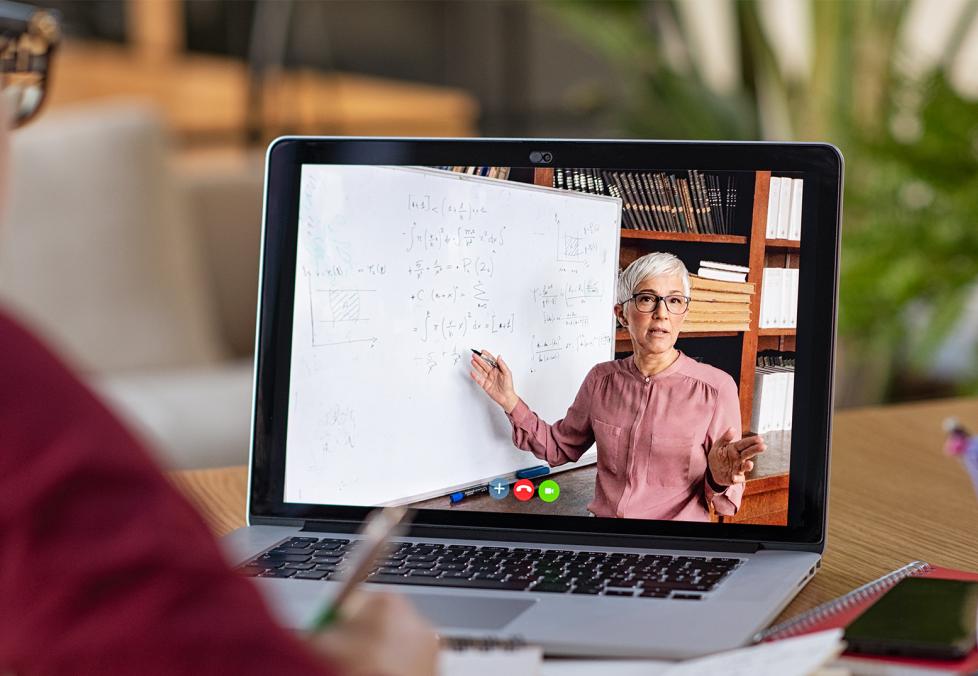 Student watching lecture on laptop