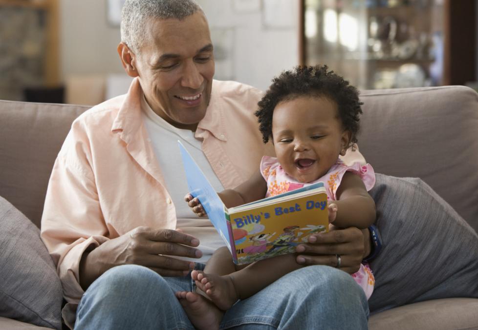 Contact lens options for presbyopia. Man reading to baby.