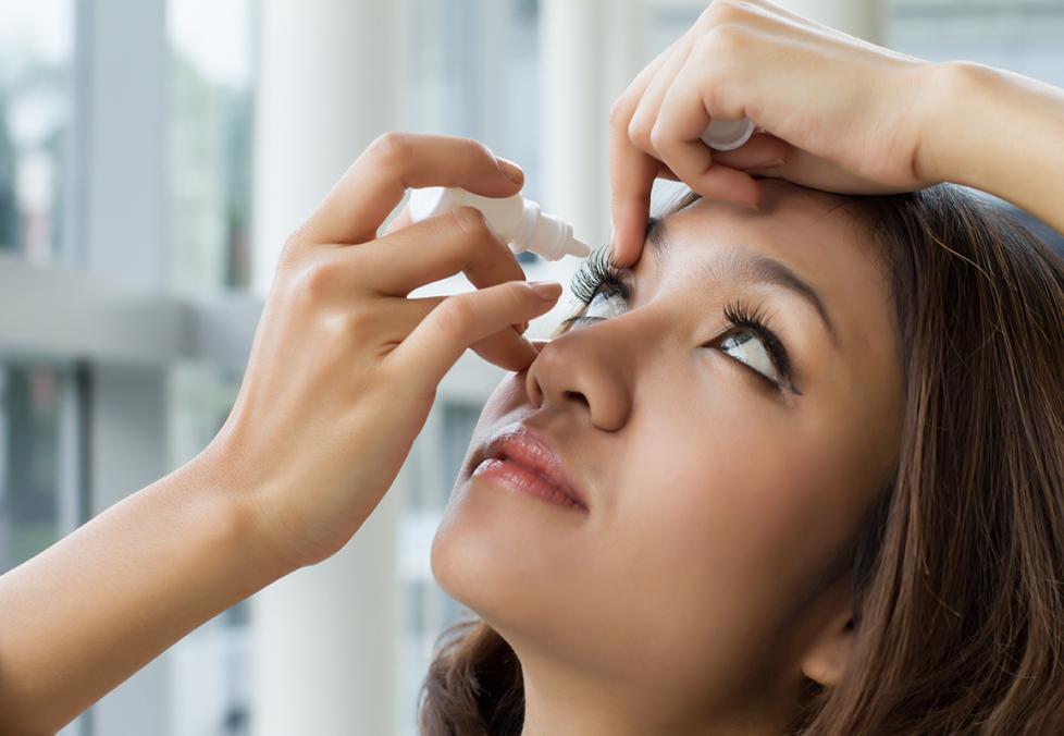 Person taking eye drops