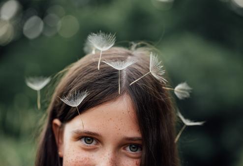 Kid with dandelions on head