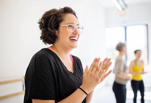 Woman smiling and clapping