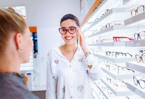 A woman shopping for glasses at a store