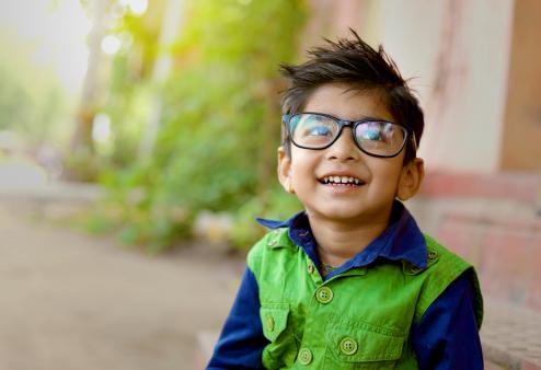 A young boy wearing glasses