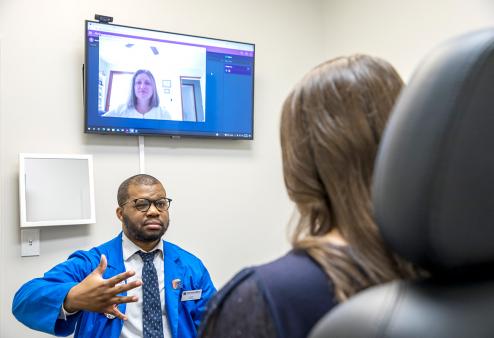 A woman is having a digital eye exam at America's Best