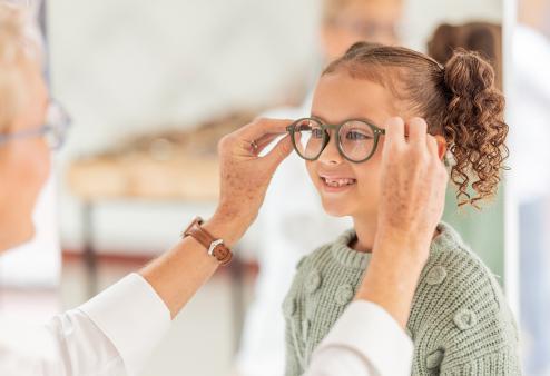 Kid trying on glasses