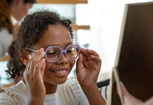 Kid trying on glasses