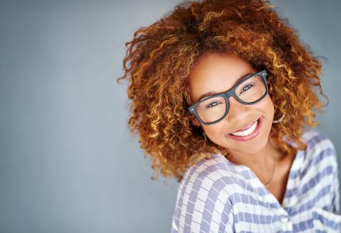 Building an eyeglasses wardrobe doesn't have to break the bank. Woman in stylish frames.