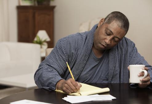 man writing down questions