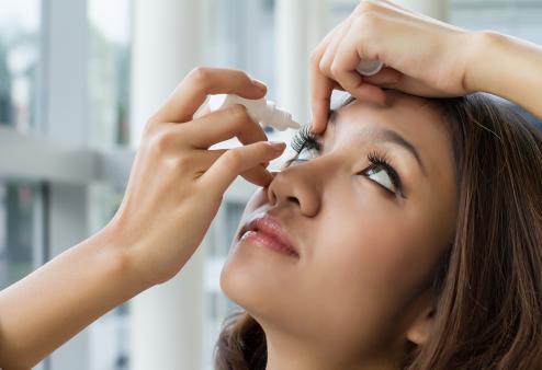 Person taking eye drops